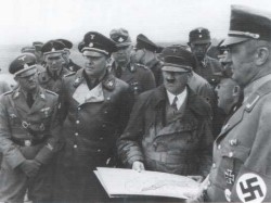 Auf dem neuen Deich wird Adolf Hitler und Reichsbauernführer Richard Walter Darre (links von Hitler) über den neuen Koog informiert
