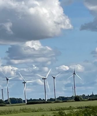 5 Windkraftanlagen vor wolkigem Himmel